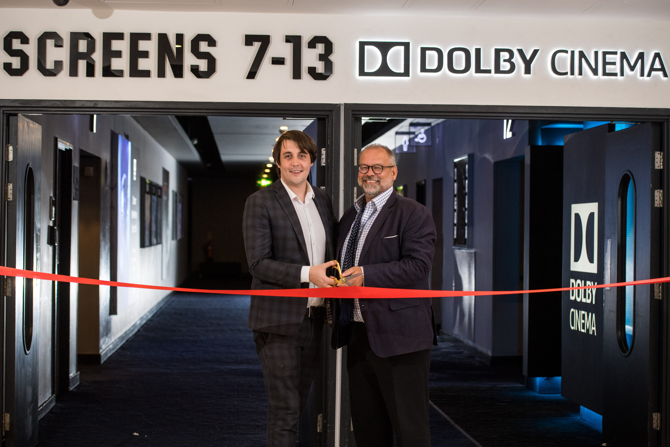 Julian Stanford, Senior Director, Dolby Cinema Europe (right), and Dan Formby, GM, ODEON Manchester Trafford Centre (left) cut the ribbon for the brand-new Dolby Cinema at ODEON Trafford Centre. Photo: Jon Park