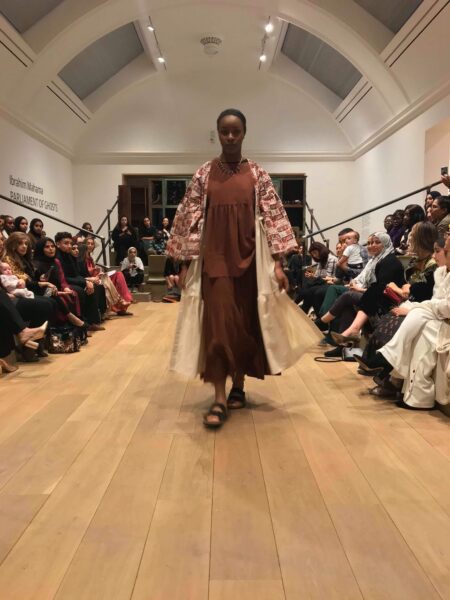 Model walking down catwalk showcasing design