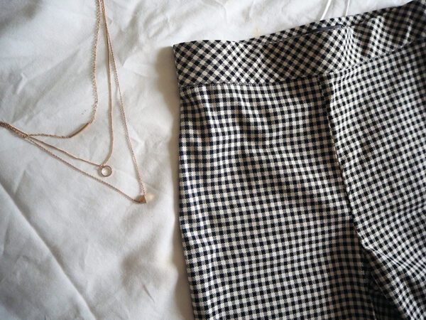 Checked trousers and gold necklace