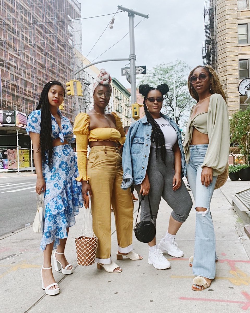 Vareity of denim garments and yellow co-ord outfit before a city landscape