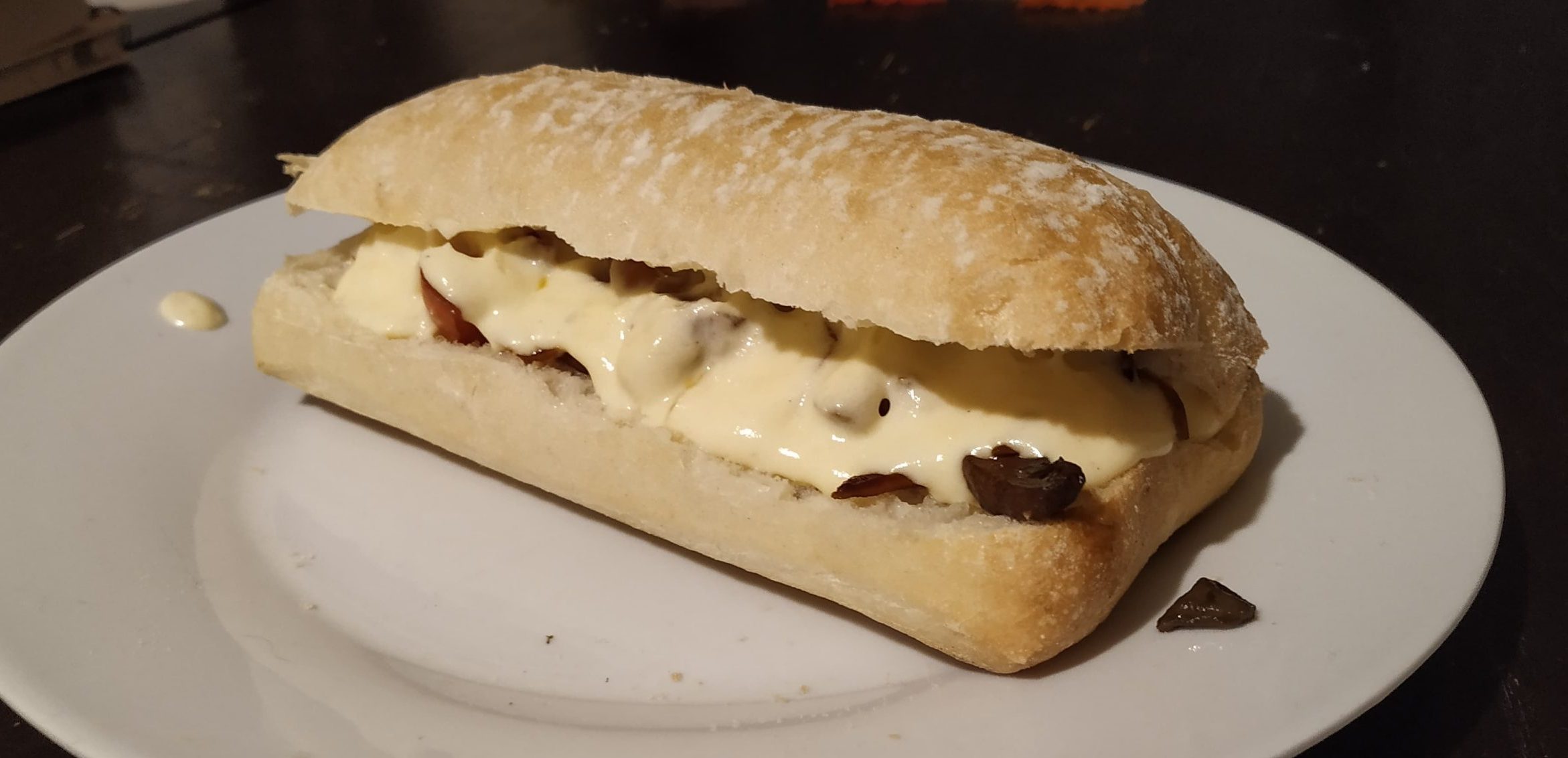 ciabatta roll with veg and gooey cheese sauce