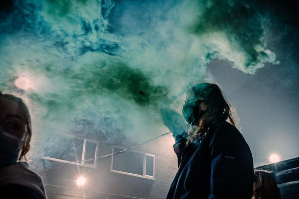 Students set off blue smoke bombs at protest in Fallowfield