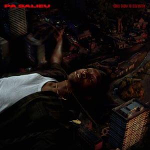 Artist Pa Salieu lies amongst a darkly lit cityscape