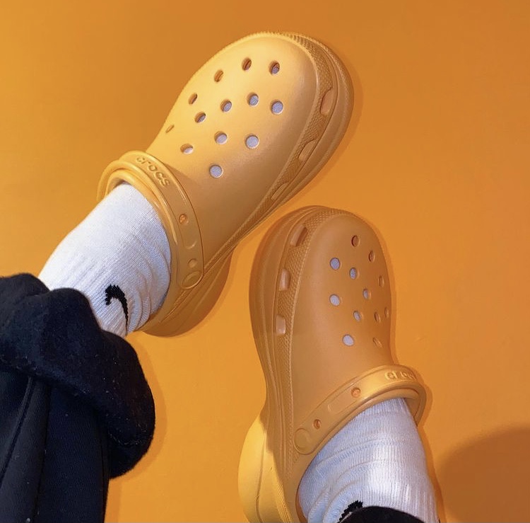 Person wearing orange crocs