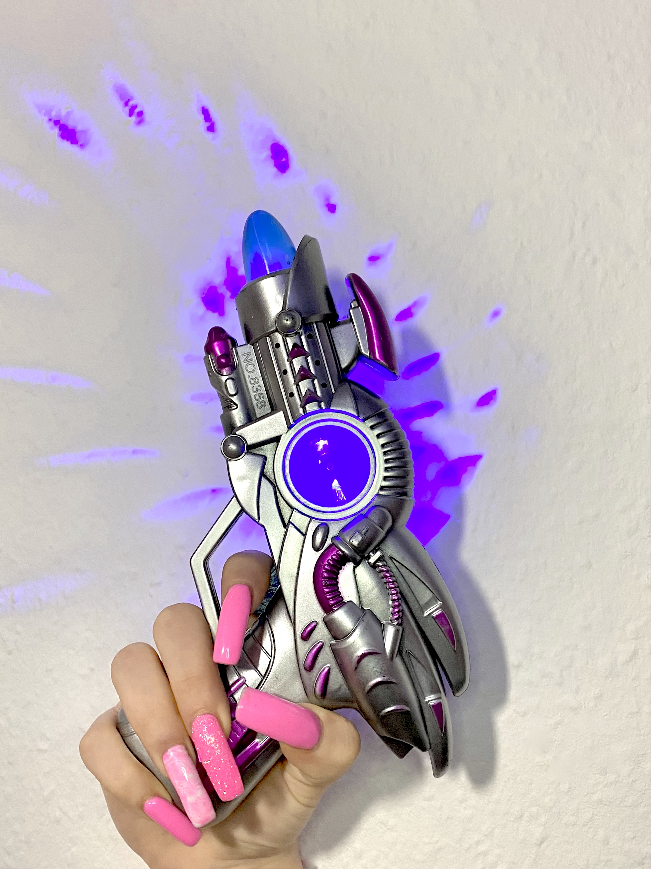Space gun and glitzy nails for a space girl look