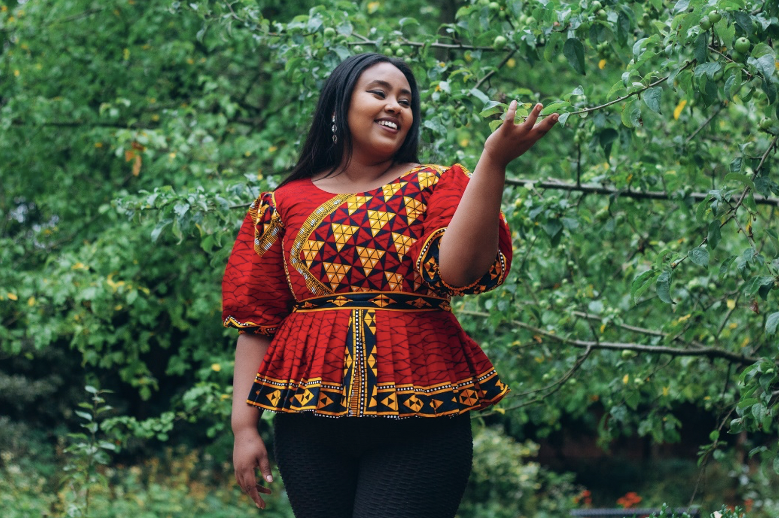Photo of a black women modelling a garment with a Cultureville print 