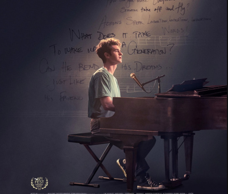 Andrew Garfield as Jonathan Larson playing the piano