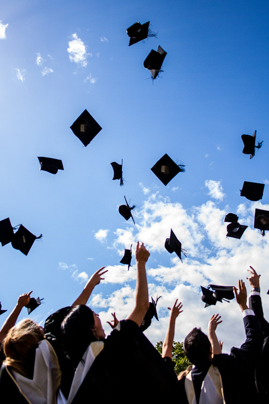 Graduation caps thrown in the air