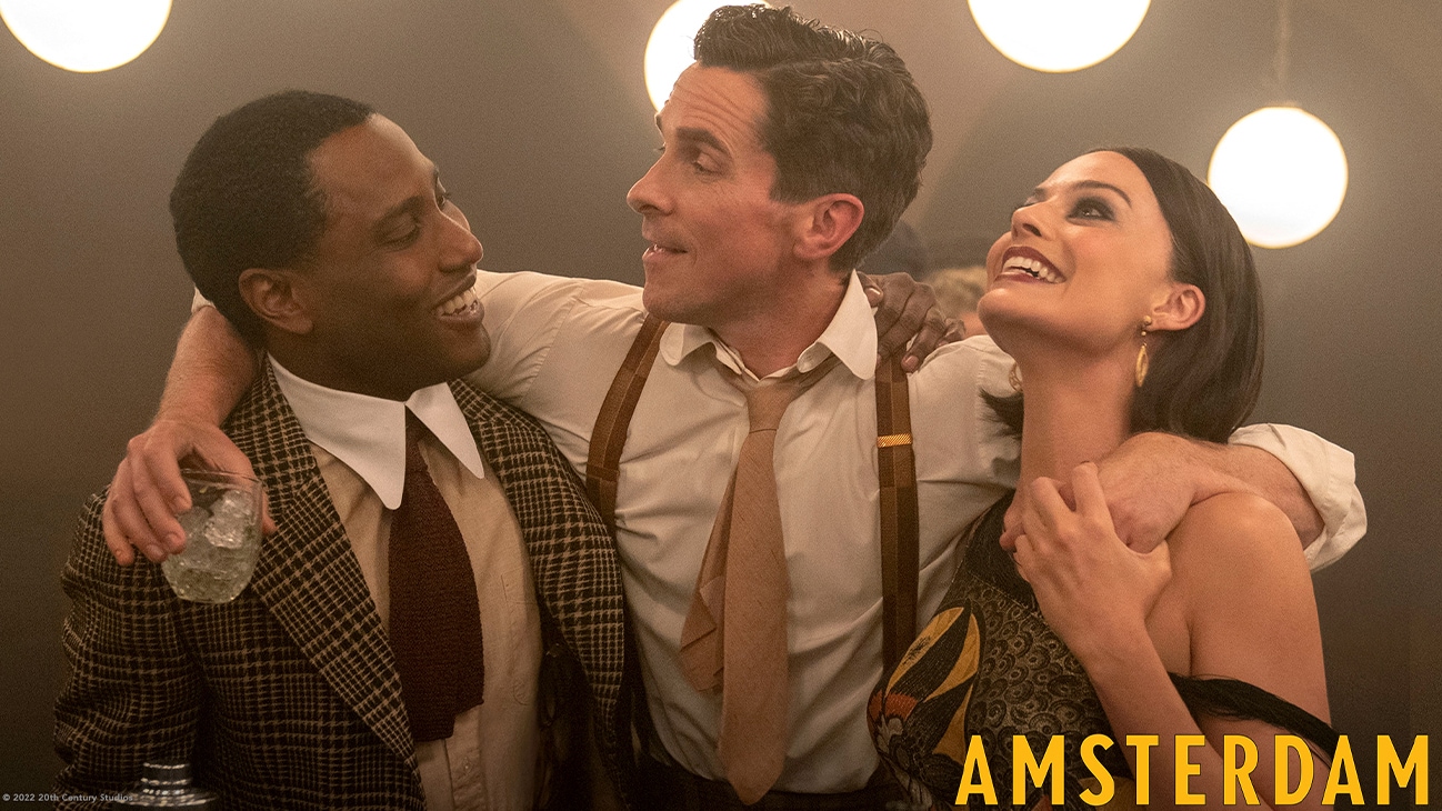 margot robbier, john david washington and christian bale hug and smile