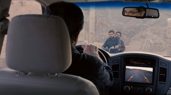shot from backseat of two men on a motorbike