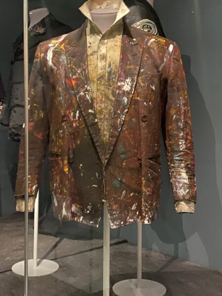 Brown suit jacket with paint stains
