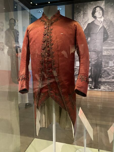 Red corded silk coat embroidered with silver thread and spangles.