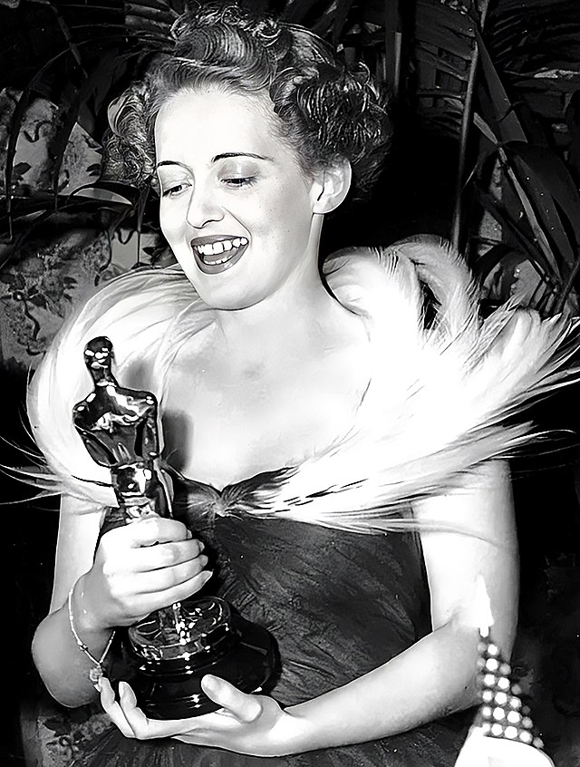 Tracy Davis Holding an Academy Award