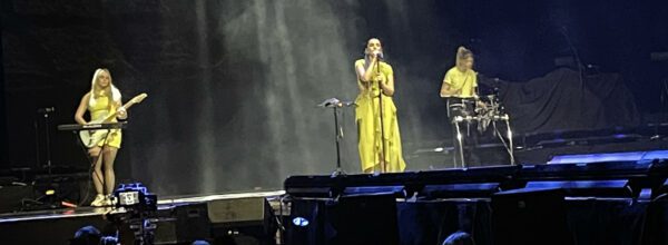 GRACEY with guitarist/keys player Sofie Veie (left) and drummer Lauren O'Donnell Anderson (right) performing at AO Arena, Manchester – Photo: Callum Webb @ The Mancunion