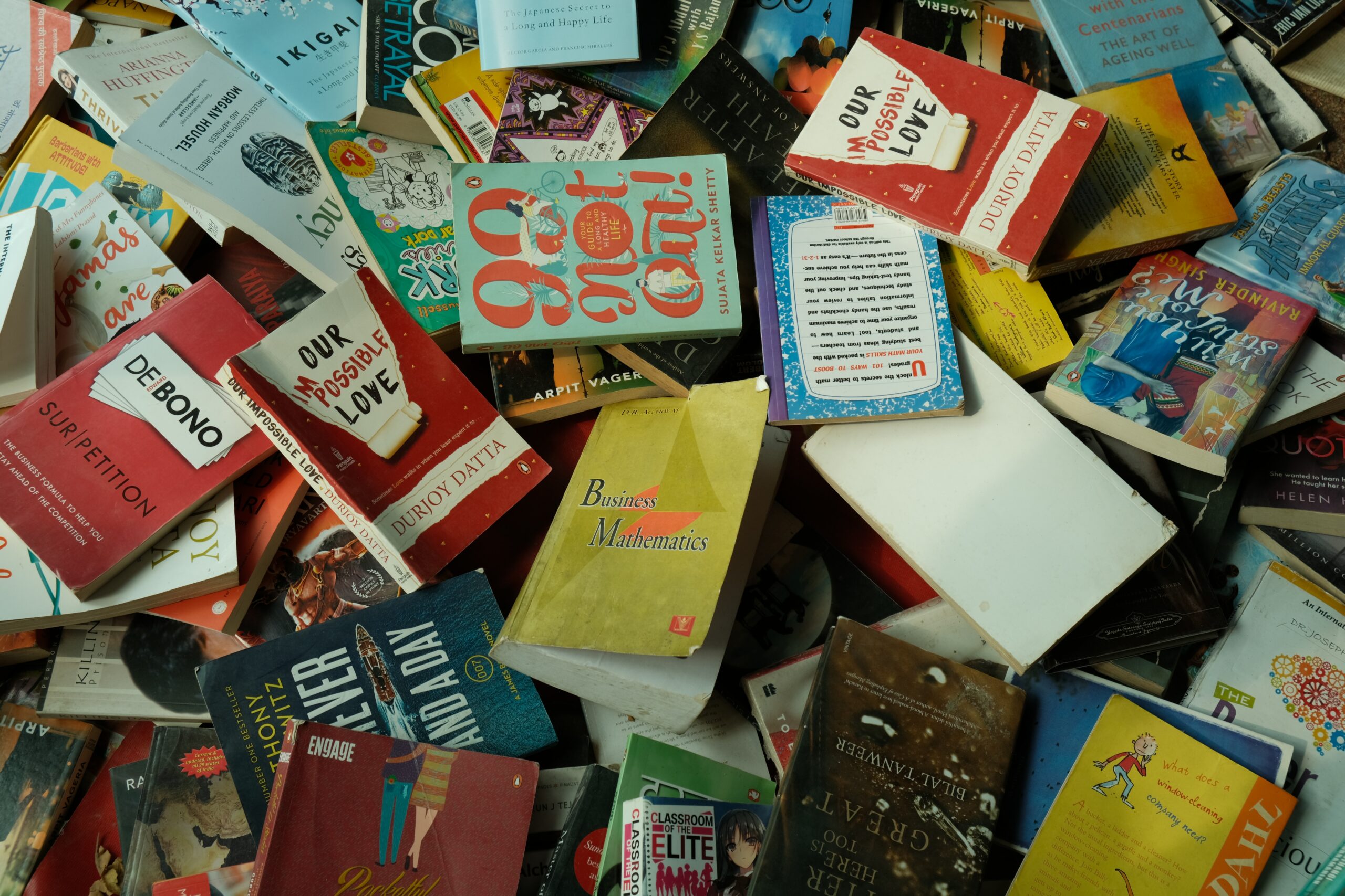 books spread and stacked across each other
