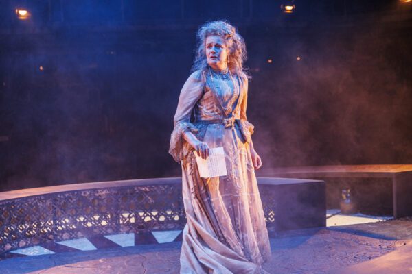 Miss Haversham takes centre stage with a concerned expression and a letter in her hand. 