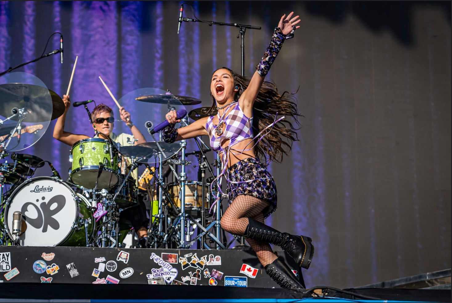 Olivia Rodrigo performing at Glastonbury 2022 jumping and singing on stage
