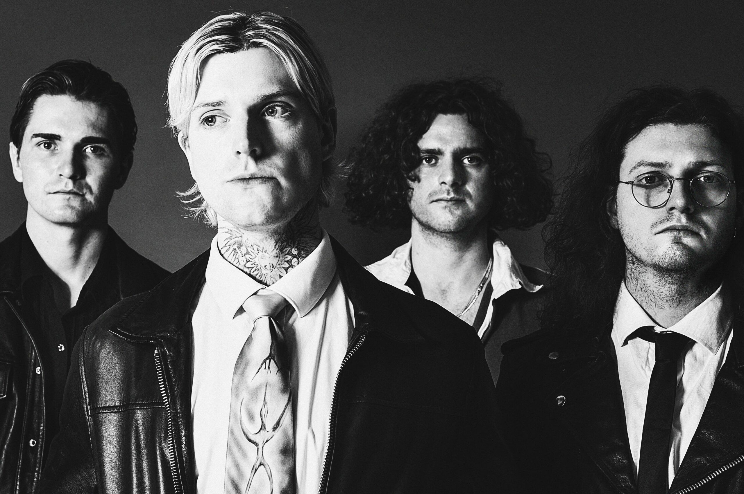Sundara Karma in black and white. Left to right: Dom Cordell (bass), Oscar Pollock (vocals, guitar), Ally Baty (guitar), Haydn Evans (drums).