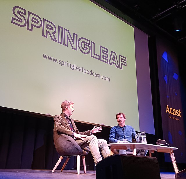 Mike Wozniak interviewing James Acaster on stage