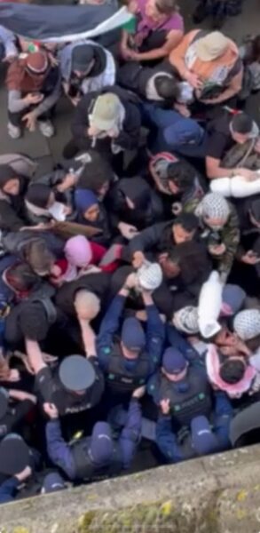 Police holding back protesters