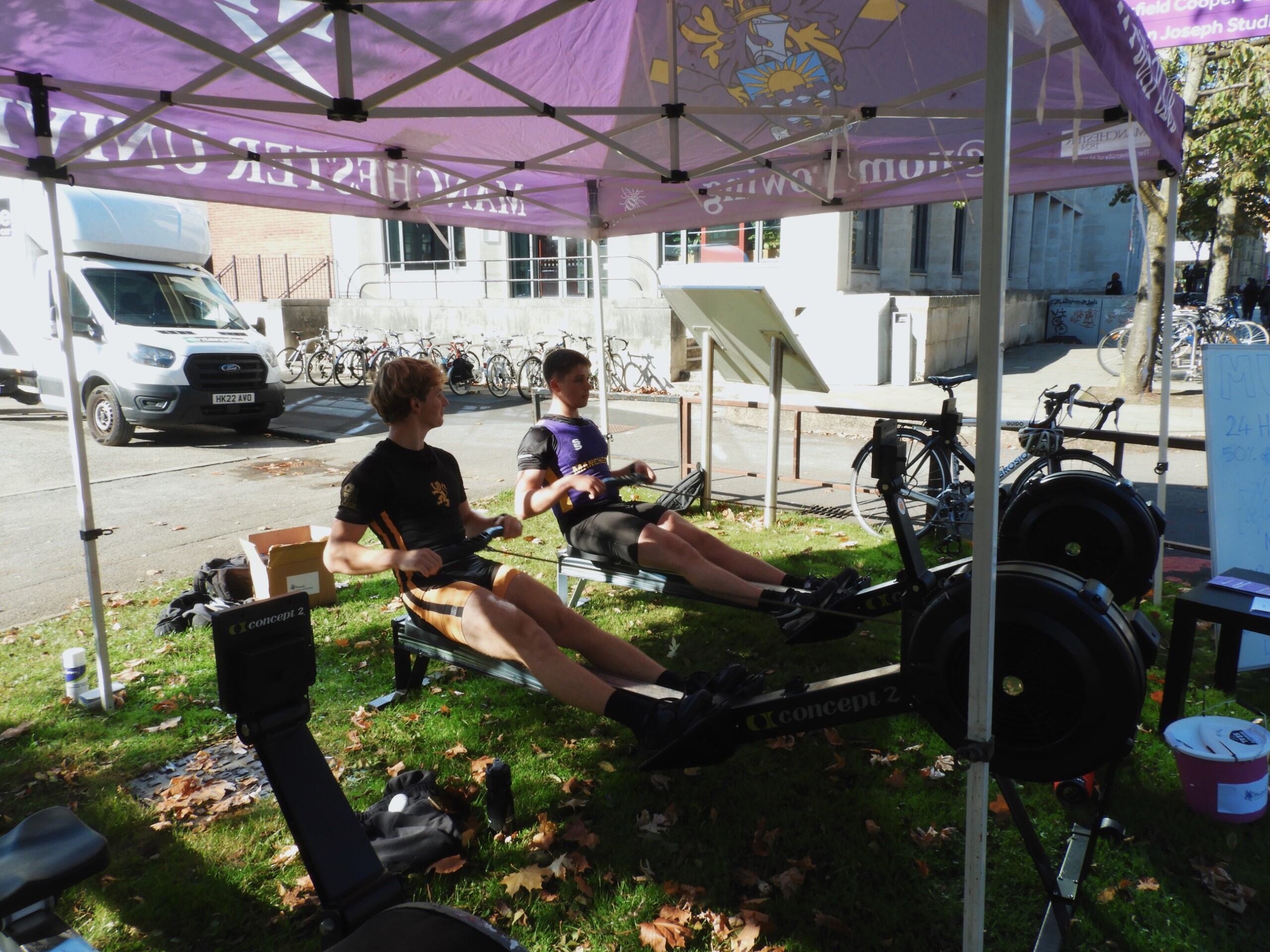 Two Manchester University Boat Club members on the rowing machines