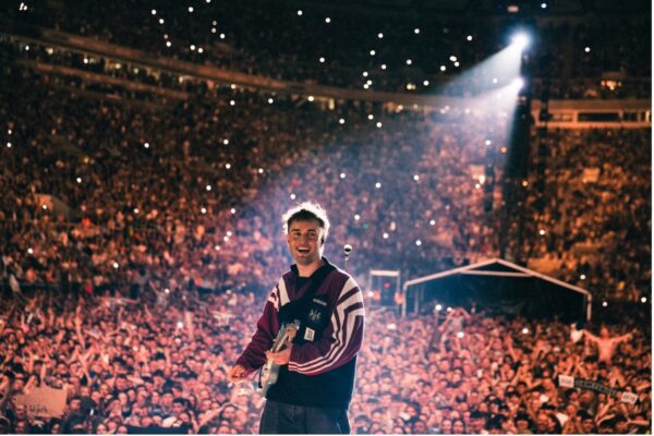 Sam Fender performing on stage 