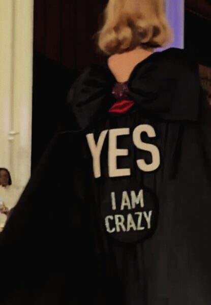 Runway fashion displaying a spin on 'the little black dress' with typography saying " Yes, I Am Crazy"