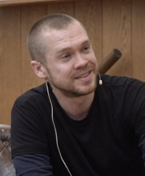 Gary Stevenson smiling while being interviewed.