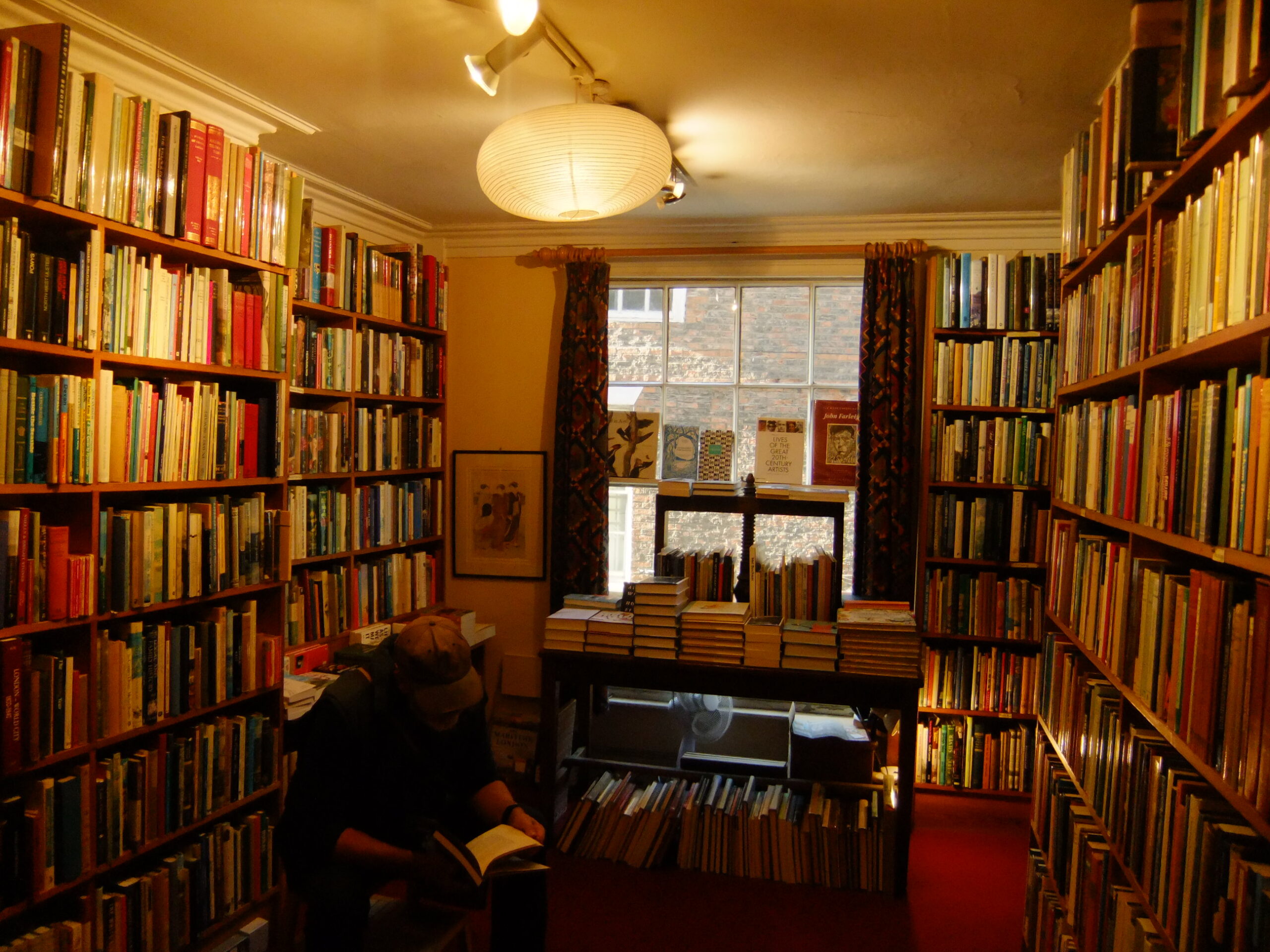 Man reading in cramped bookshop