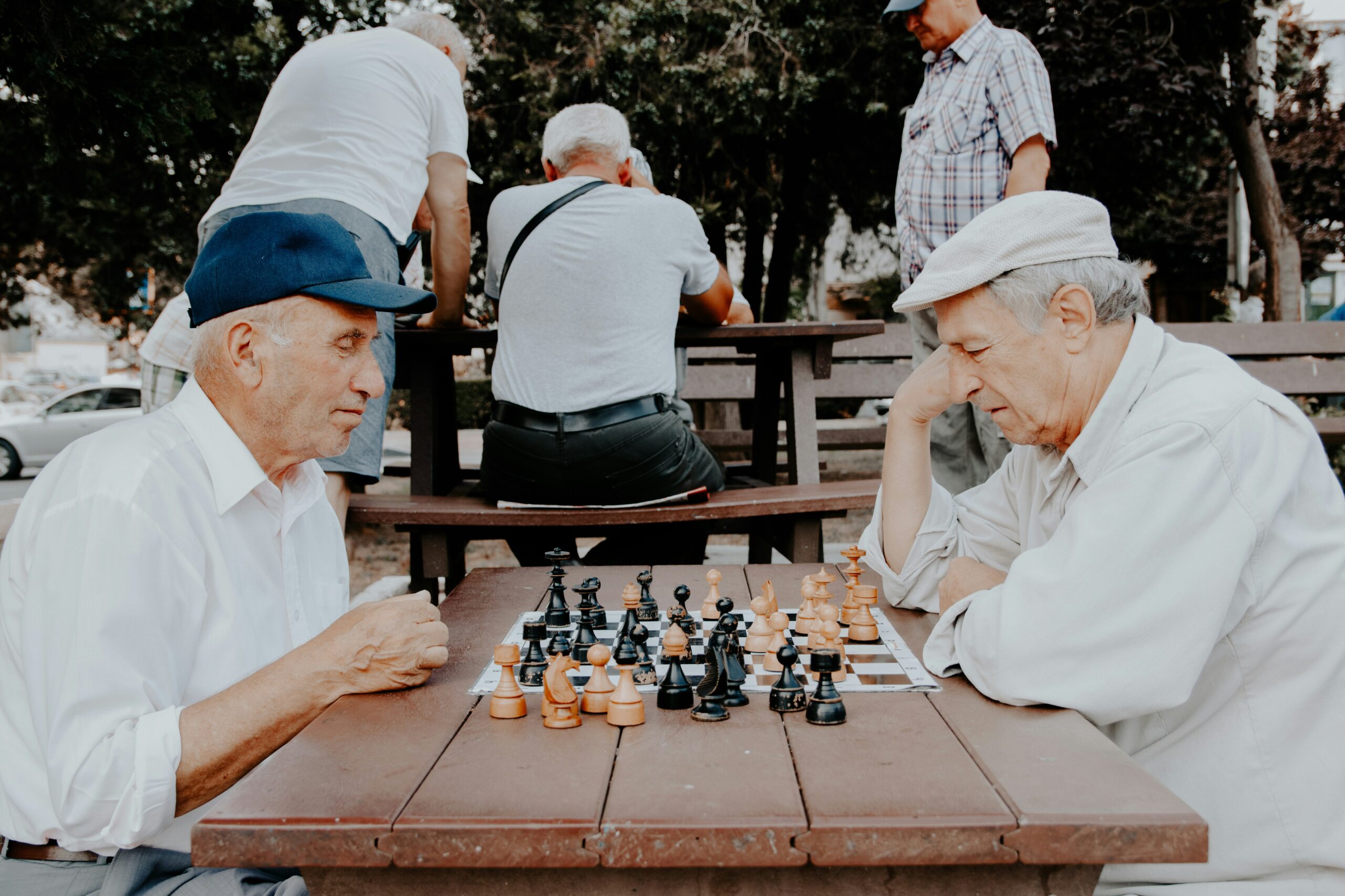 Two elderly men playing a strategic game of stress.