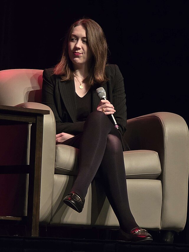 Samantha Shannon sat down, holding a microphone and addressing an audience.