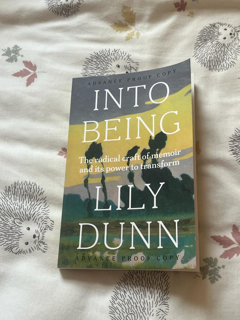 A copy of Into Being, a guide to writing memoir, placed on some bedsheets.