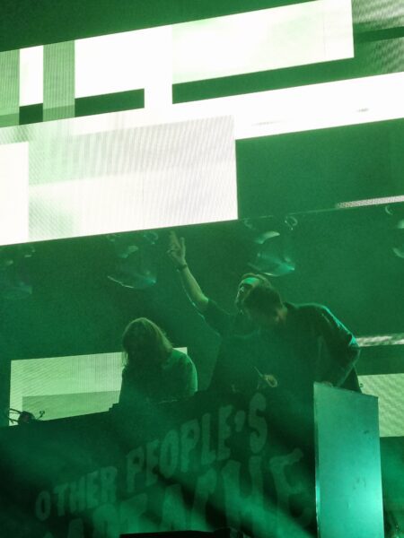 Woody, Kyle and Charlie from Bastille at the DJ turntable during 'Other People's Heartache.'
