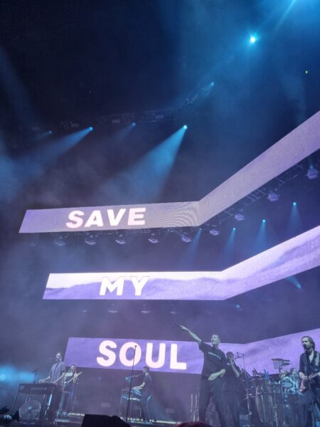 Dan smith showing the microphone to the audience during 'Save my soul'
