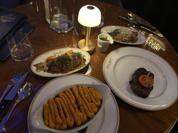 Shown are the main courses: Vegan shepherd's pie, sirloin steak, and the cauliflower cheese croquettes.
