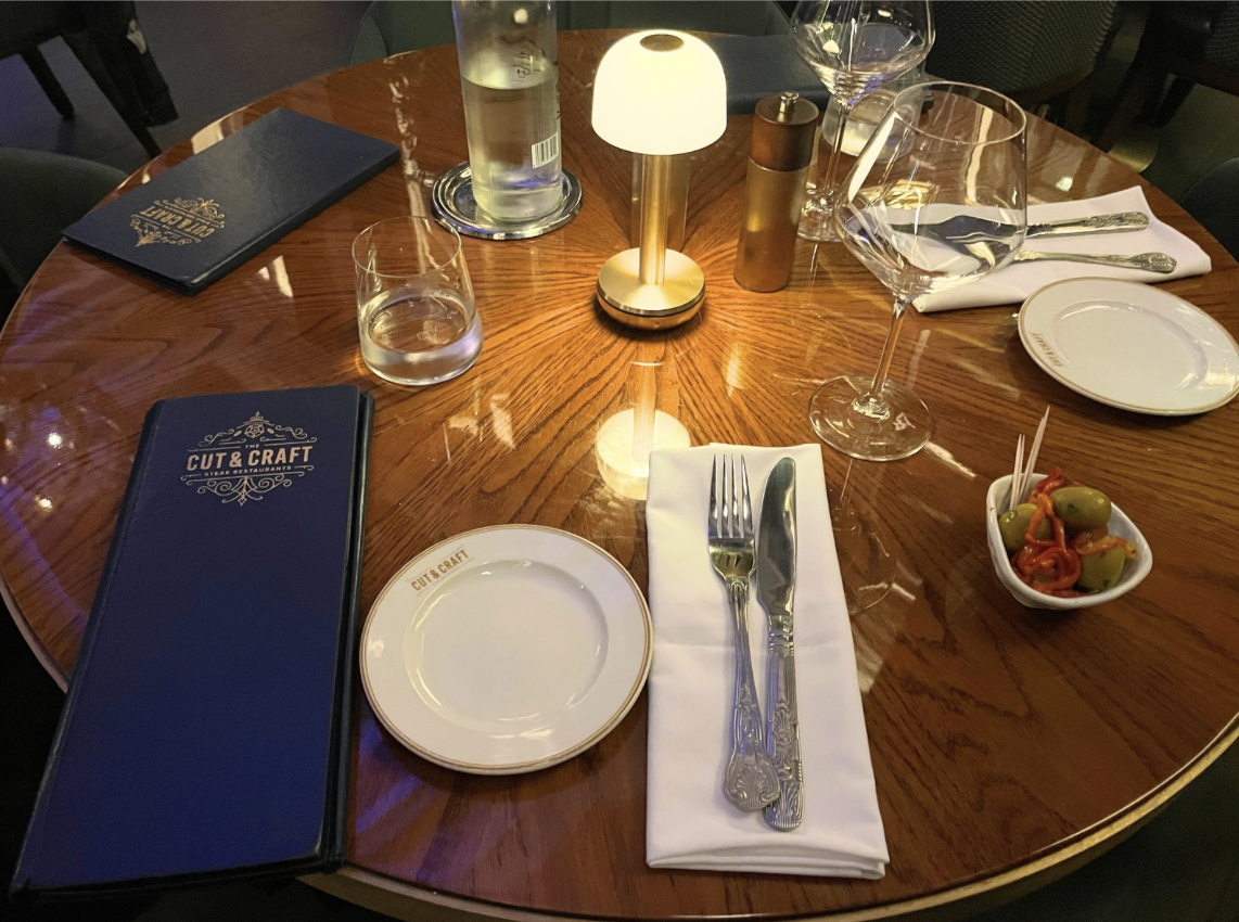 The table at The Cut & Craft, showing the menu, and the spicy olives appetiser.