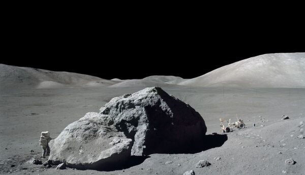 Scientist and astronaut Harrison H. Schmitt stands next to a huge, split lunar boulder during the Apollo 17 mission at the Taurus-Littrow landing site in this photograph from Dec. 13, 1972. Rock samples collected during the Apollo missions provided evidence that the Moon resulted from an object crashing into Earth in the early history of the solar system.