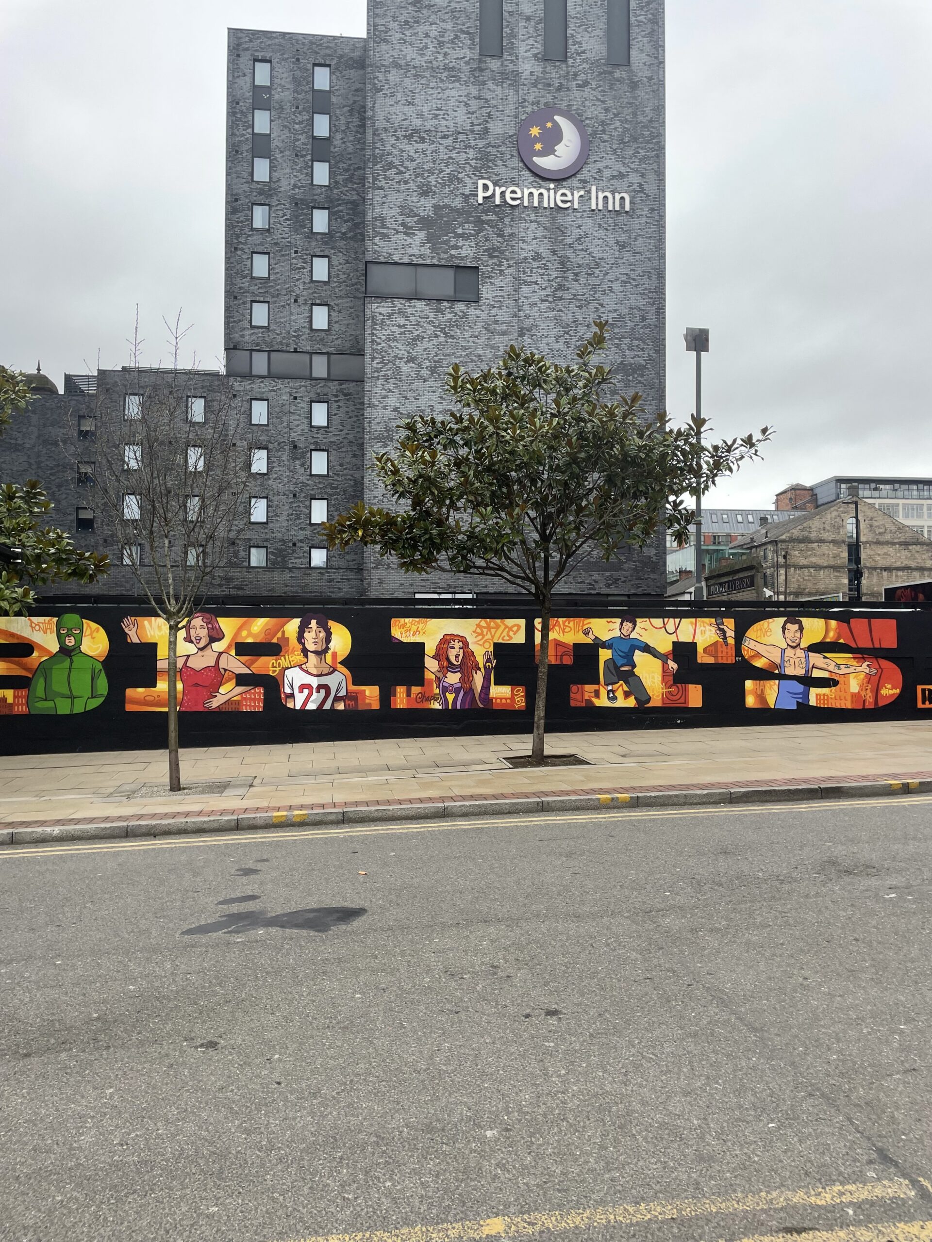 Part of BRIT Awards mural on Ducie Street. Artists such as Raye and Harry Styles are featured within each of the letters