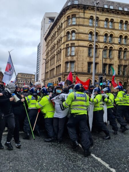 Counter protesters pushing through a police line