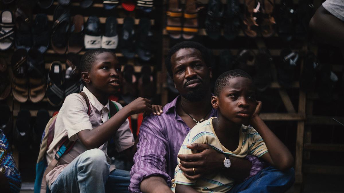 my-fathers-shadow-2025-man-sat-on-street-with-two-boys-v1